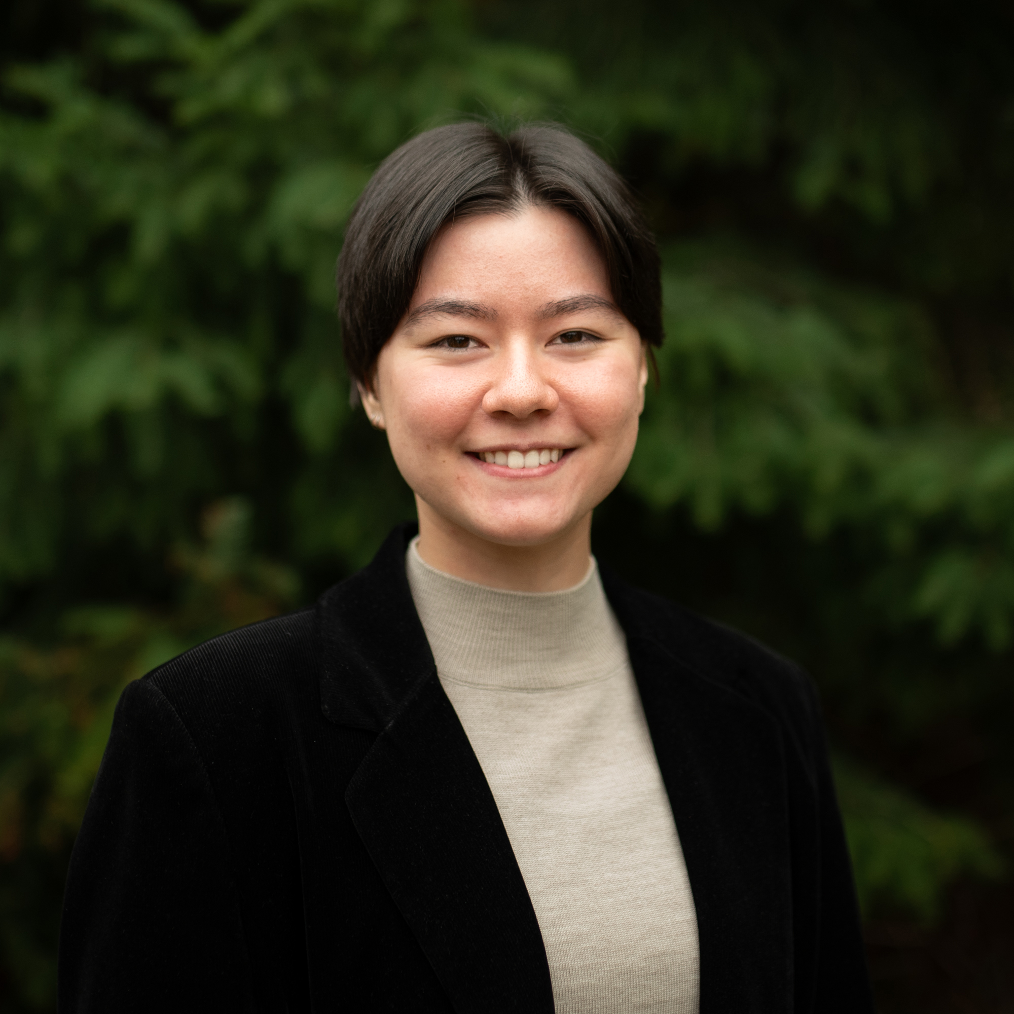 An image of Midori Davis wearing a black blazer coat.